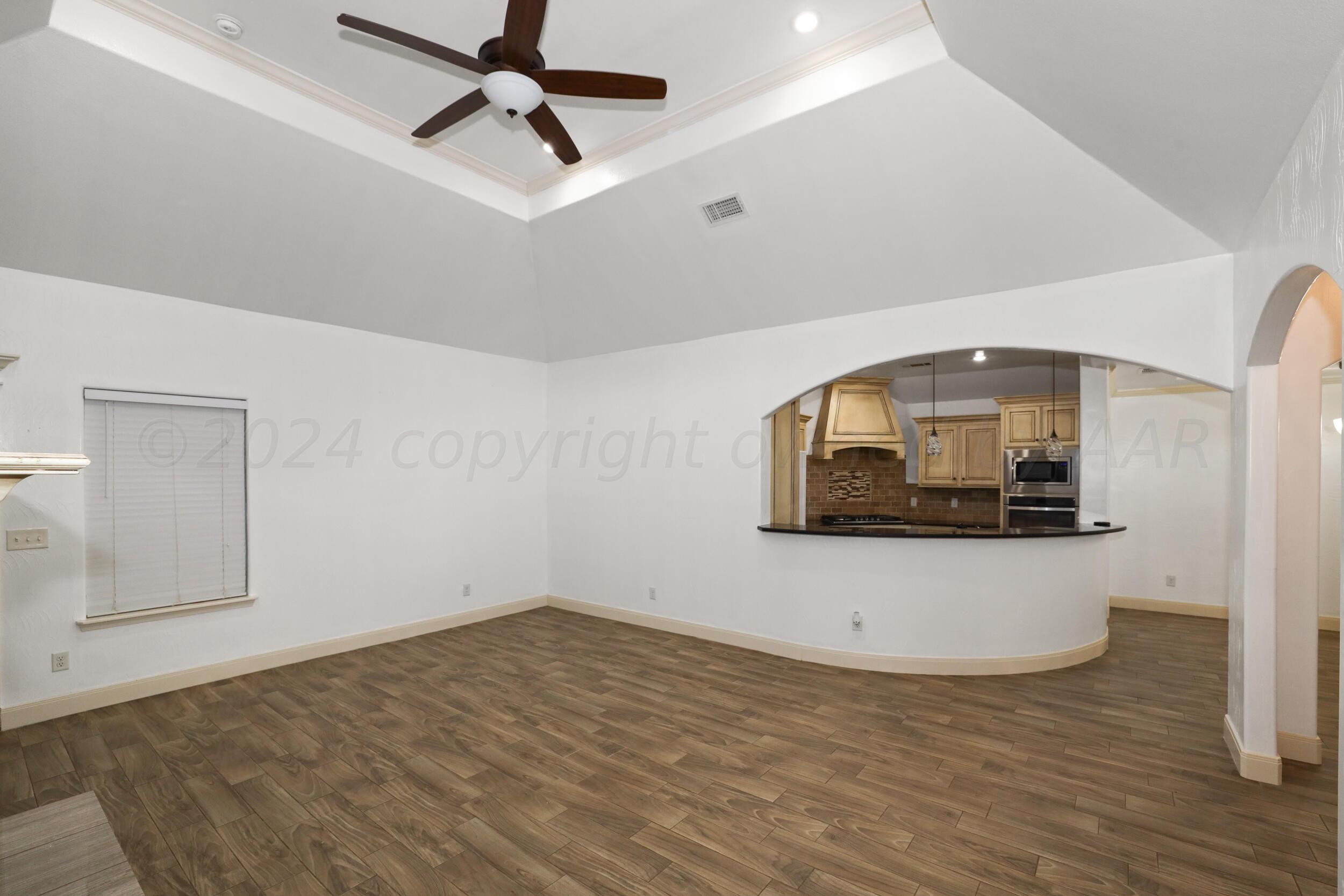 7303 Rochester Drive Amarillo, TX 79118 - Photo 12 of 38 a view of a hallway with wooden floor and cabinet