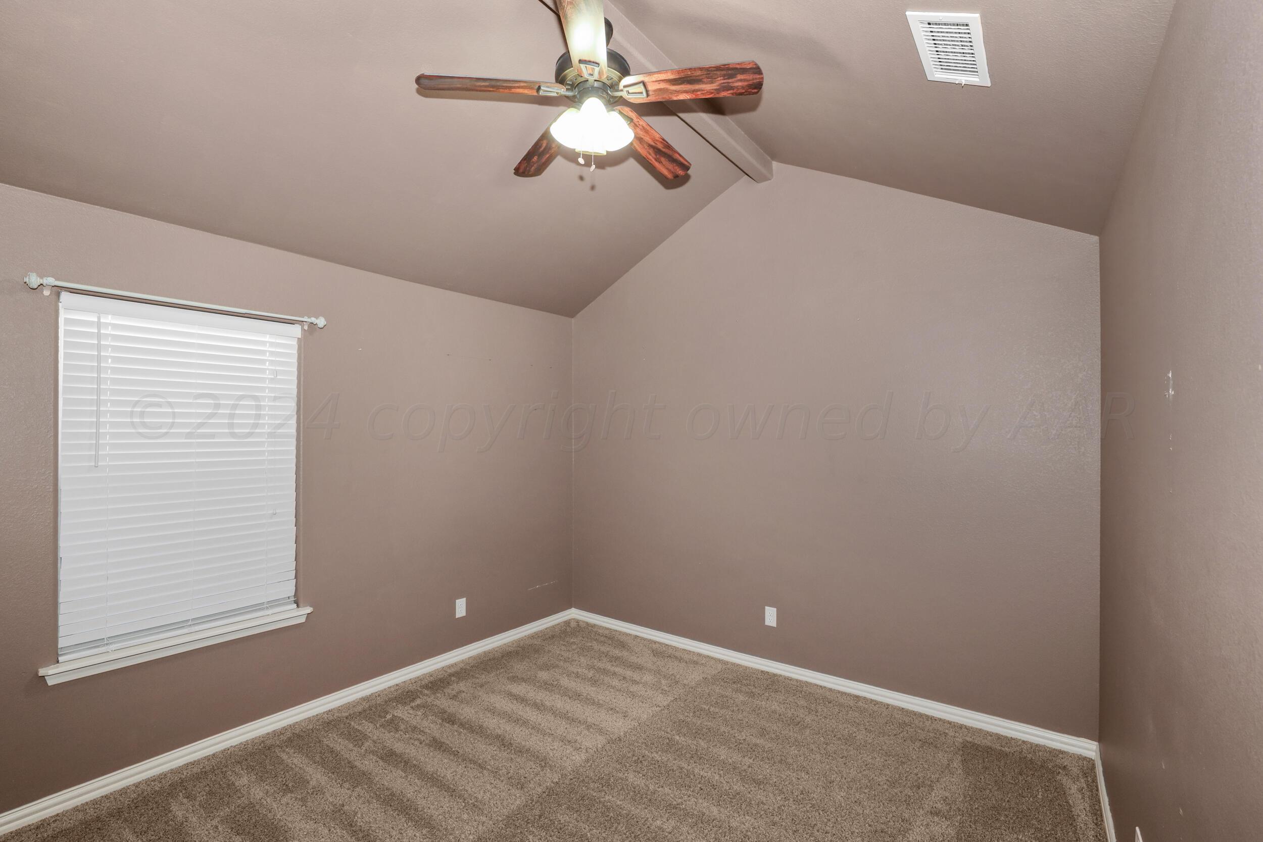 7303 Rochester Drive Amarillo, TX 79118 - Photo 17 of 38 a view of a room with a ceiling fan and a window