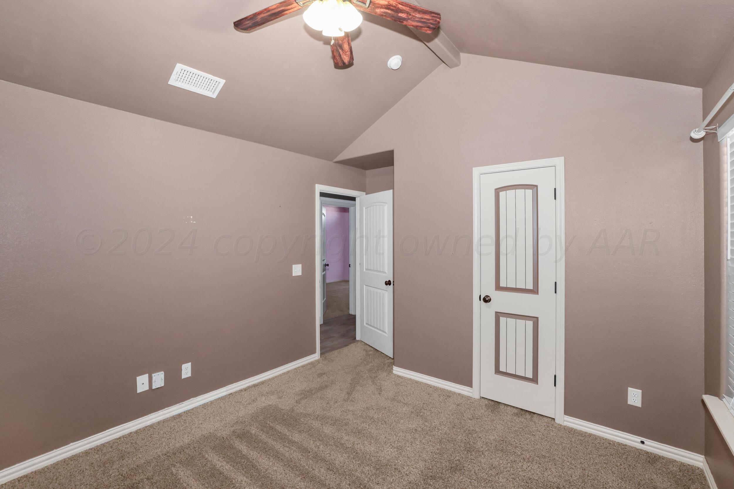 7303 Rochester Drive Amarillo, TX 79118 - Photo 18 of 38 a view of an empty room with a chandelier fan