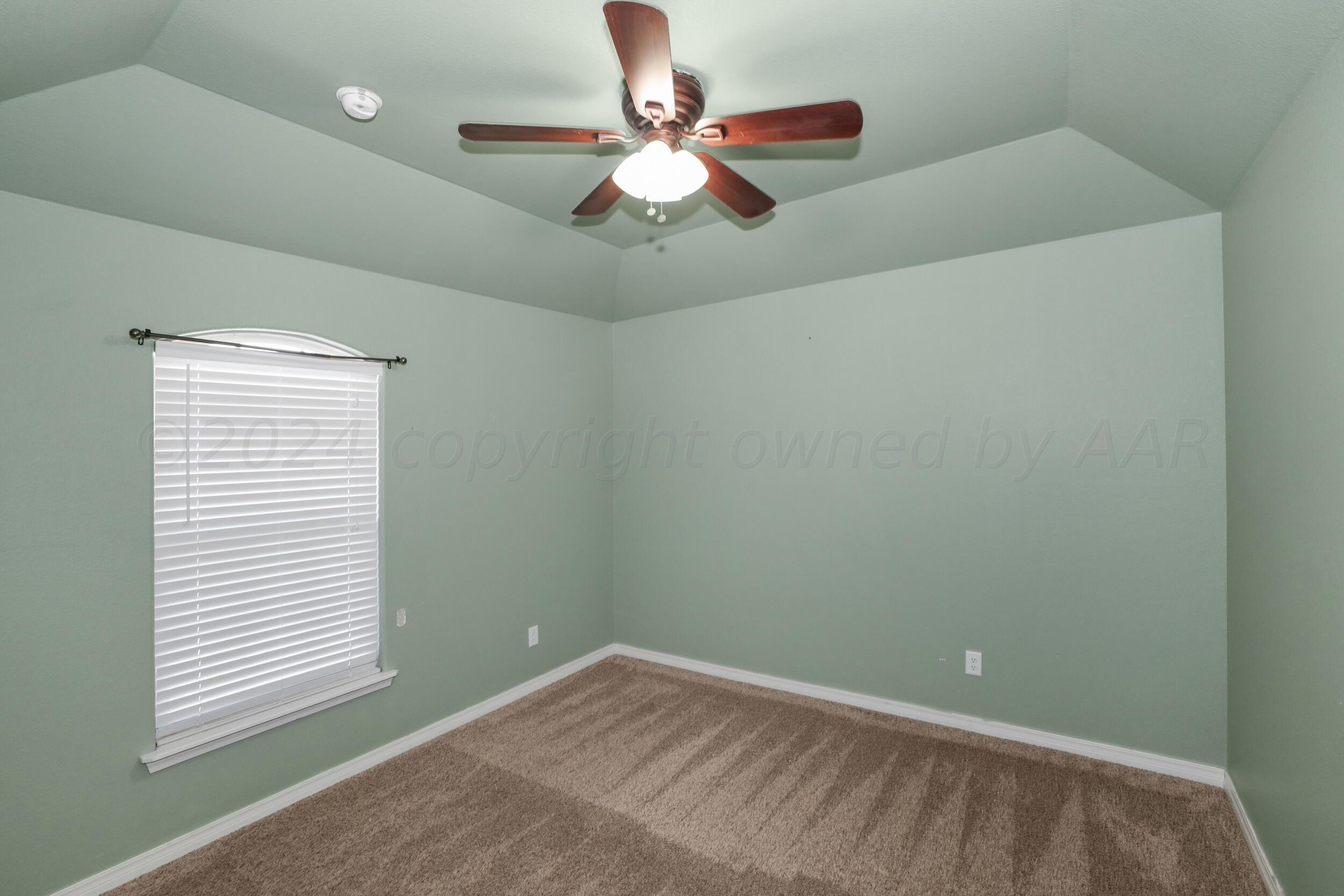 7303 Rochester Drive Amarillo, TX 79118 - Photo 19 of 38 a view of an empty room with window and a ceiling fan