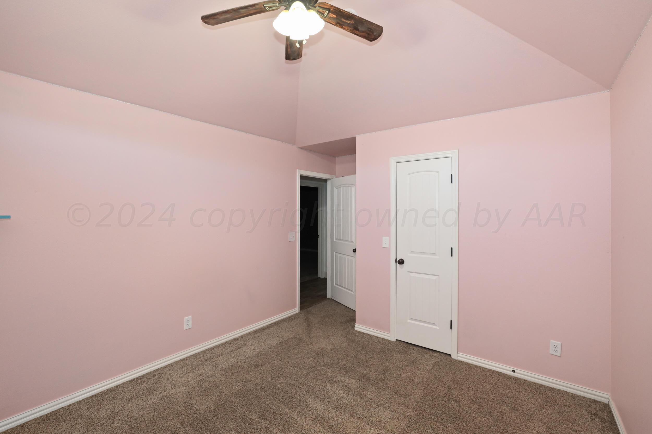 7303 Rochester Drive Amarillo, TX 79118 - Photo 23 of 38 an empty room with a chandelier fan
