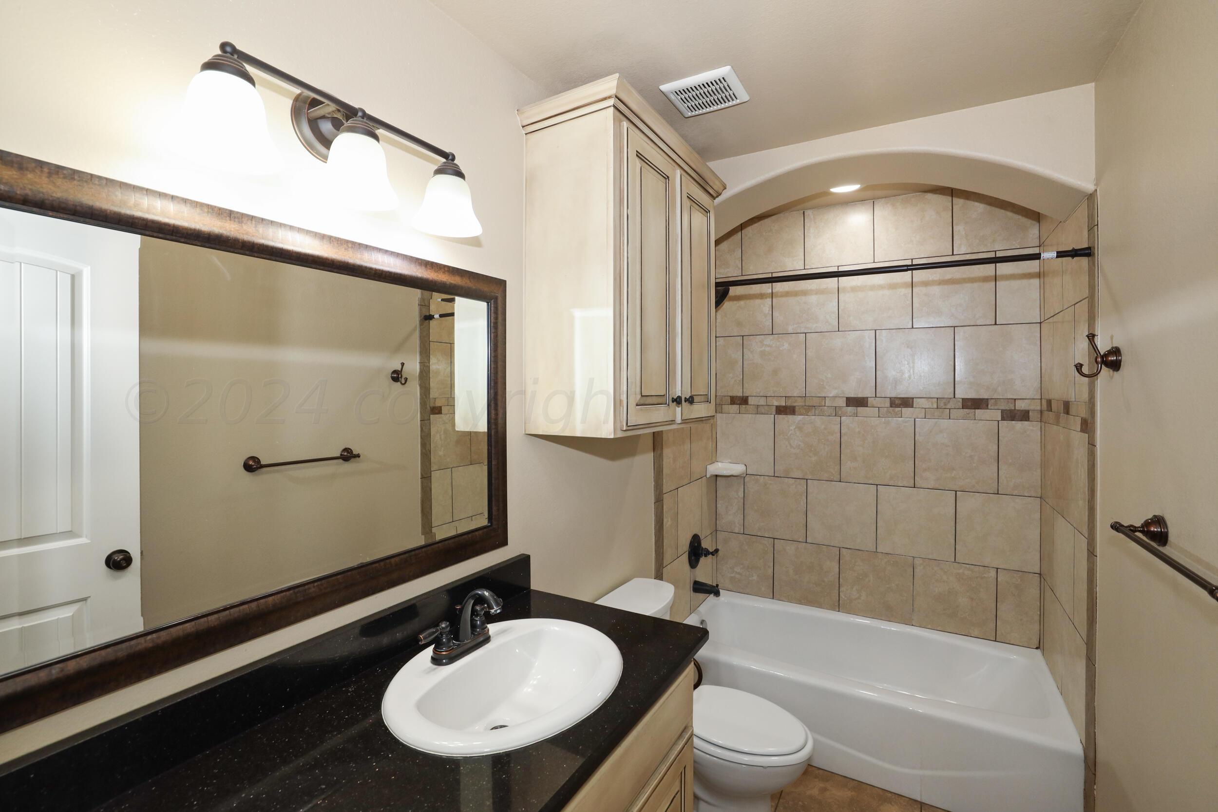 7303 Rochester Drive Amarillo, TX 79118 - Photo 25 of 38 a bathroom with a sink toilet and shower