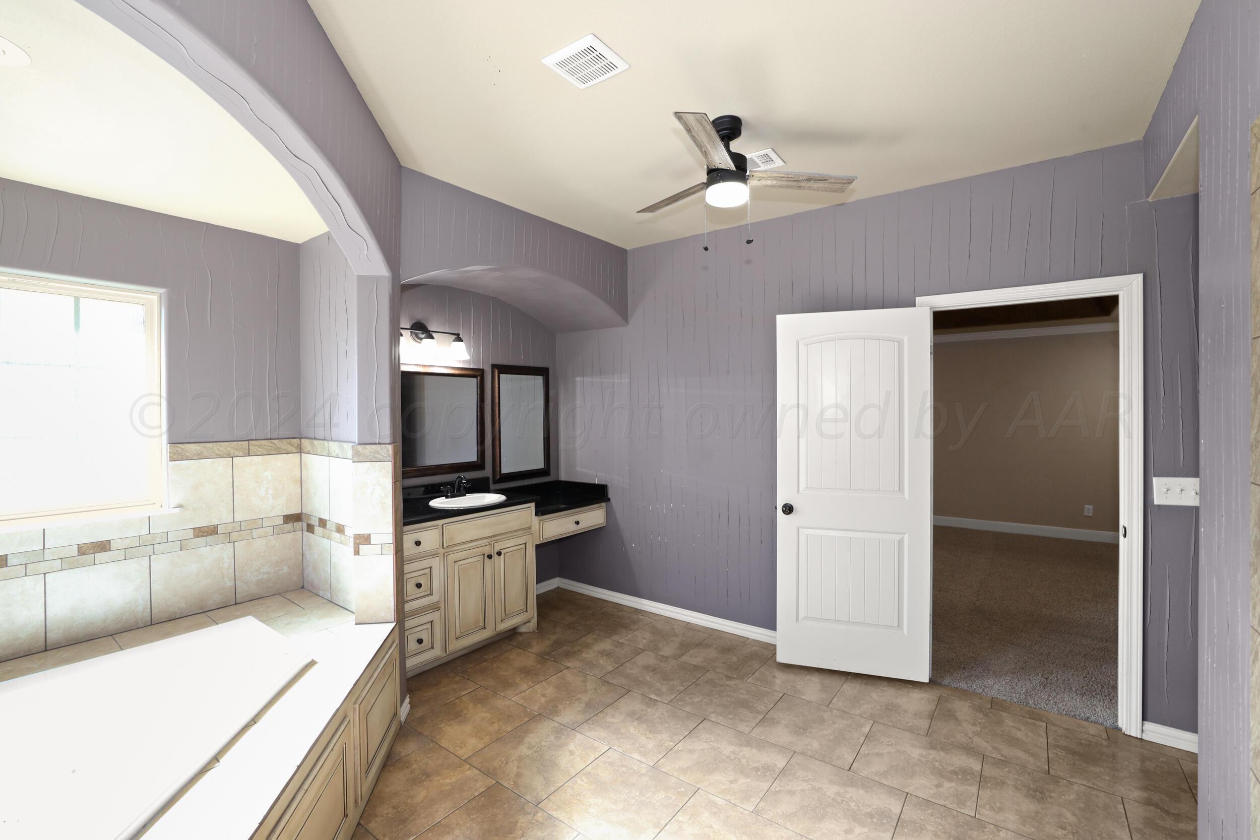 7303 Rochester Drive Amarillo, TX 79118 - Photo 28 of 38 a large kitchen with a large counter top space appliances and cabinets