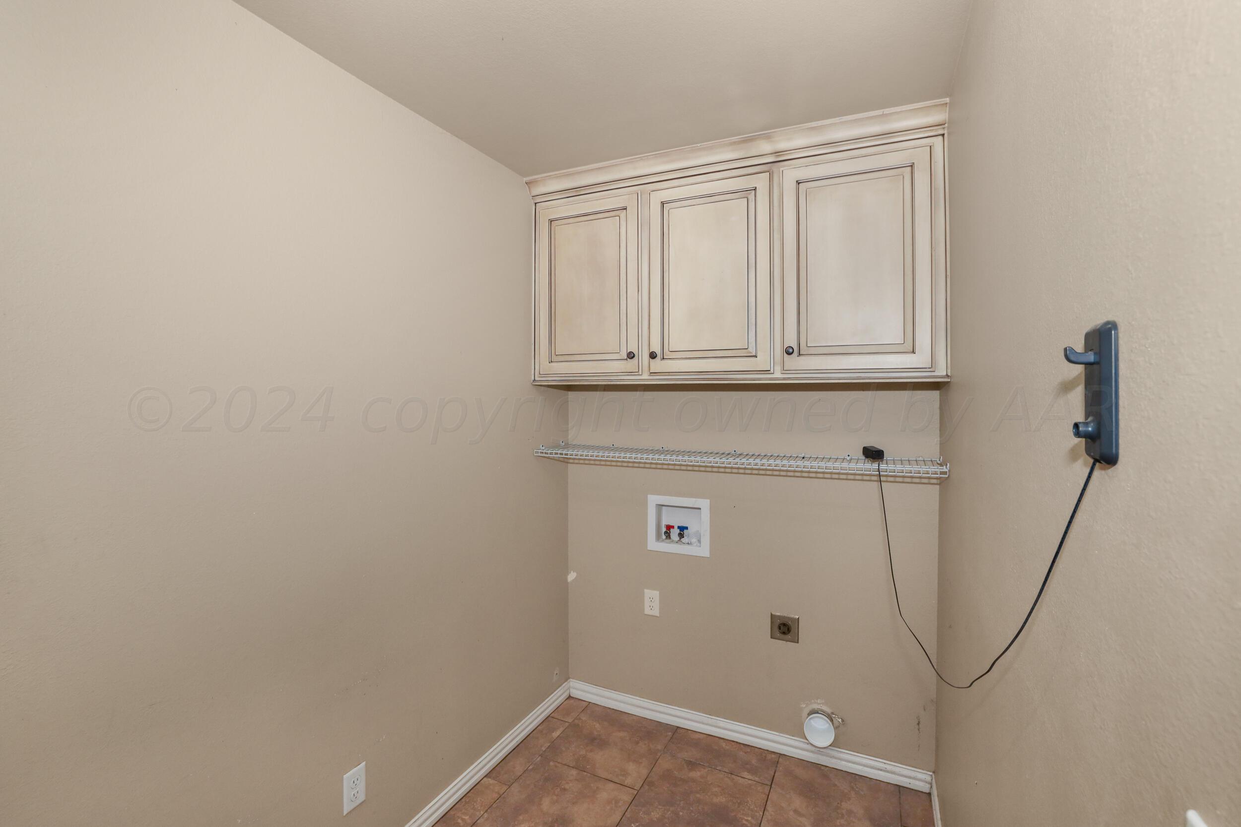 7303 Rochester Drive Amarillo, TX 79118 - Photo 33 of 38 a view of a utility room with cabinet