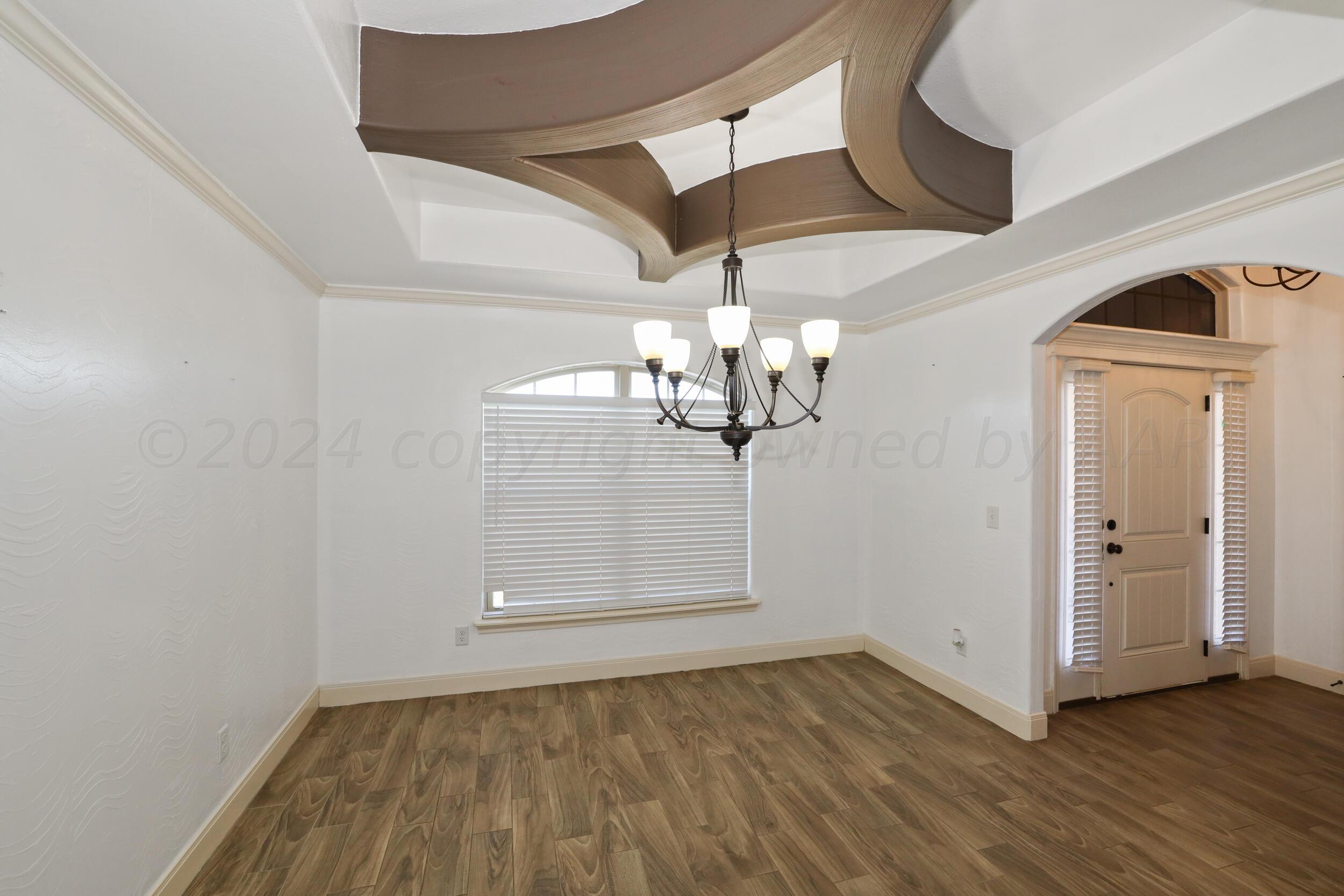 7303 Rochester Drive Amarillo, TX 79118 - Photo 5 of 38 a view of empty room with wooden floor