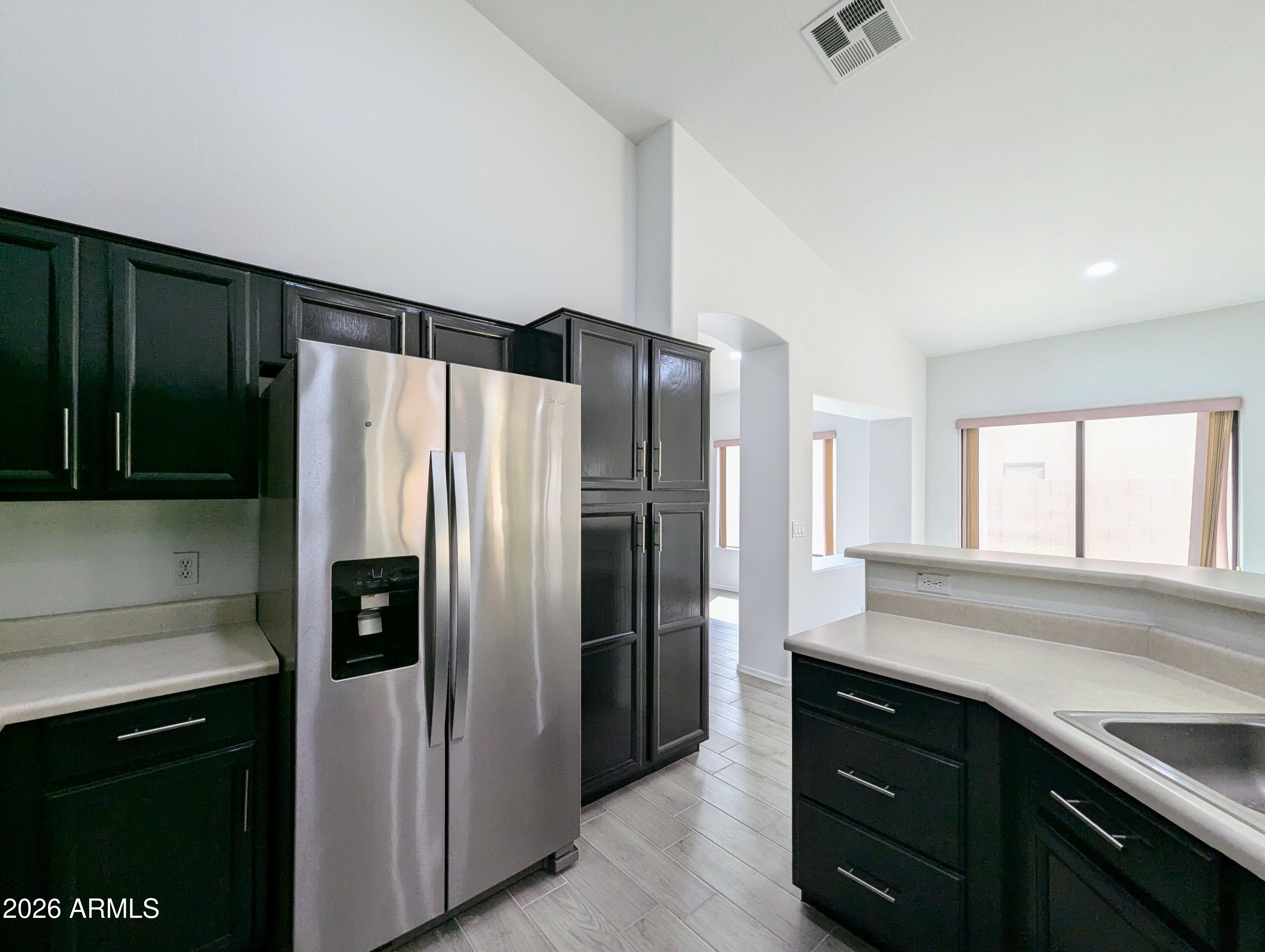 5424 West Wagoner Road Glendale, AZ 85308 - Photo 15 of 37 a kitchen with a refrigerator and a sink