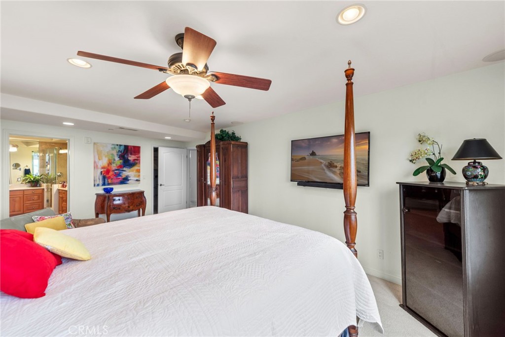 412 Arenoso Lane San Clemente, CA 92672 - Photo 14 of 23 a bedroom with a bed and a chandelier