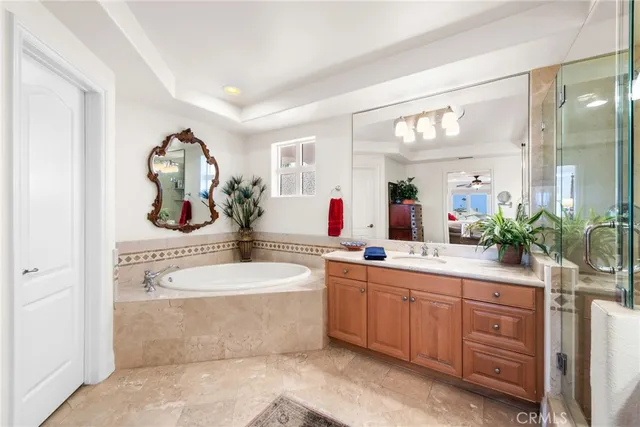 a spacious bathroom with a sink a mirror and a bathtub