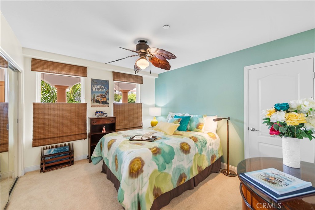 412 Arenoso Lane San Clemente, CA 92672 - Photo 17 of 23 a bedroom with a bed and a chandelier