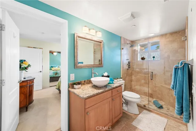 a spacious bathroom with a granite countertop sink and a mirror