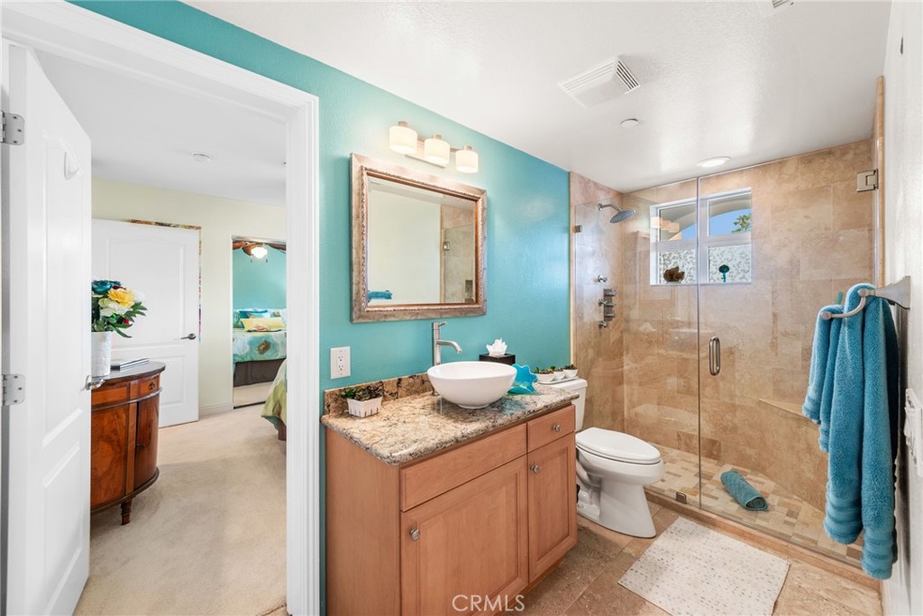 412 Arenoso Lane San Clemente, CA 92672 - Photo 18 of 23 a spacious bathroom with a granite countertop sink and a mirror
