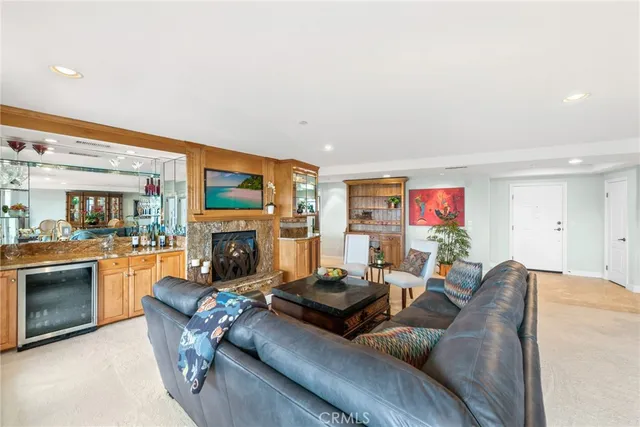 a living room with furniture a fireplace and a floor to ceiling window