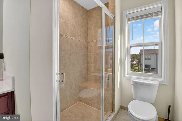 a white toilet next to a bathroom sink