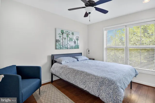 a bedroom with a bed a couch and a window