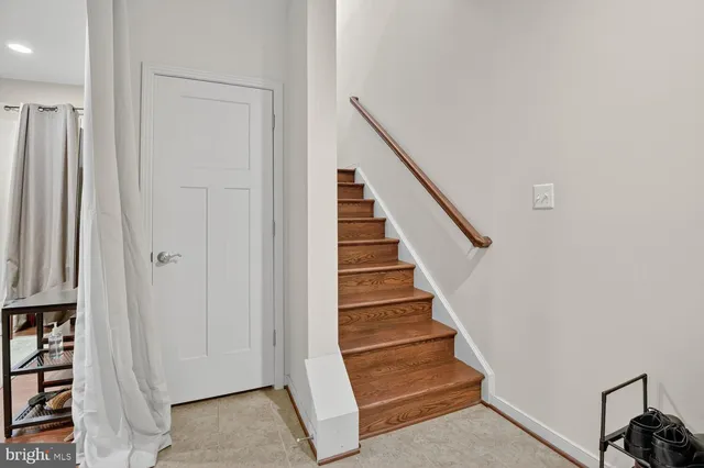 a view of entryway with wooden floor and stairs