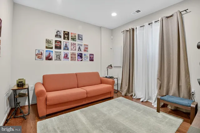 a living room with furniture a ceiling fan and a window