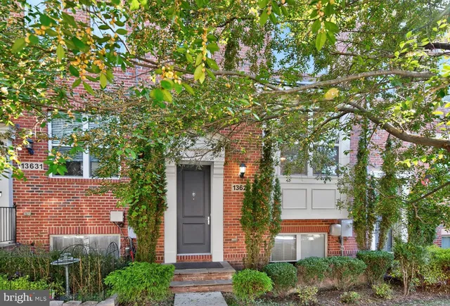 front view of a house with a tree