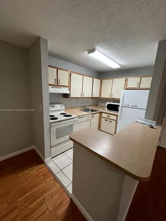 a view of a hallway view with wooden floor and staircase