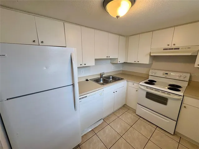 a kitchen with cabinets and appliances