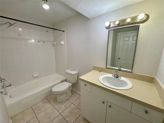 a bathroom with a sink toilet tub and shower