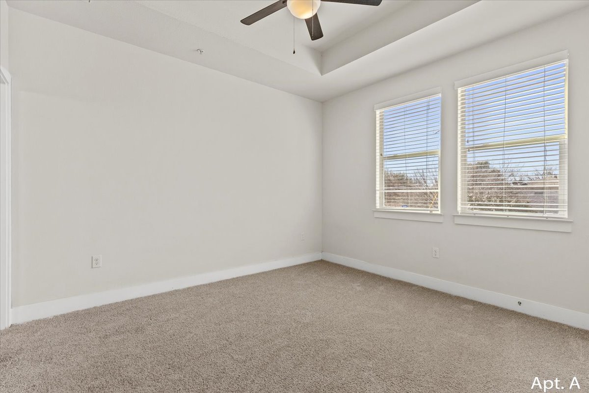 2225 Katy Lane, Unit A Georgetown, TX 78626 - Photo 15 of 22 Carpeted spare room with ceiling fan and a raised ceiling