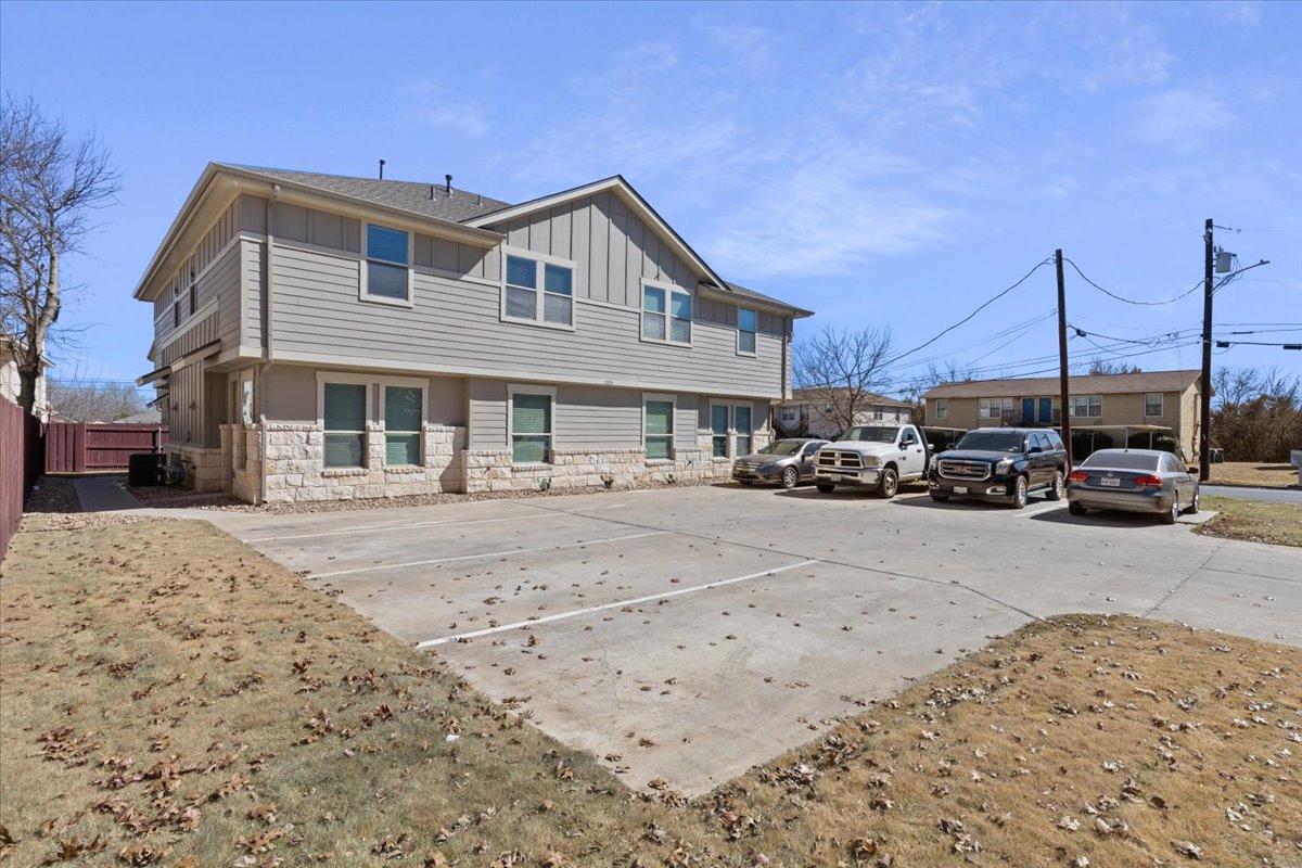 2225 Katy Lane, Unit A Georgetown, TX 78626 - Photo 2 of 22 Side view property featuring board and batten siding and stone siding