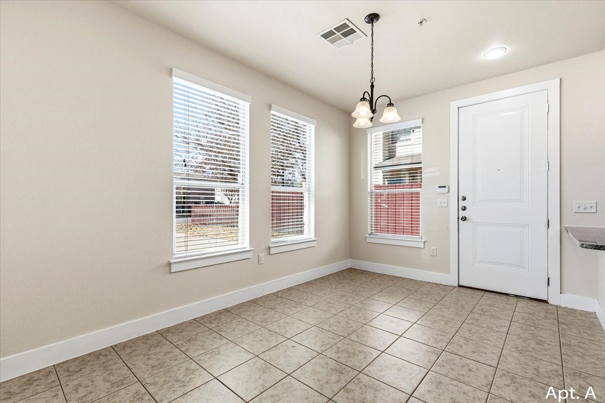 2225 Katy Lane, Unit A Georgetown, TX 78626 - Photo 5 of 22 Unfurnished dining area featuring suspended lighting and light tile patterned floors