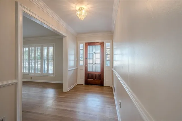 a view of a room with wooden floor and white walls