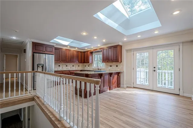 a kitchen with granite countertop stainless steel appliances and refrigerator