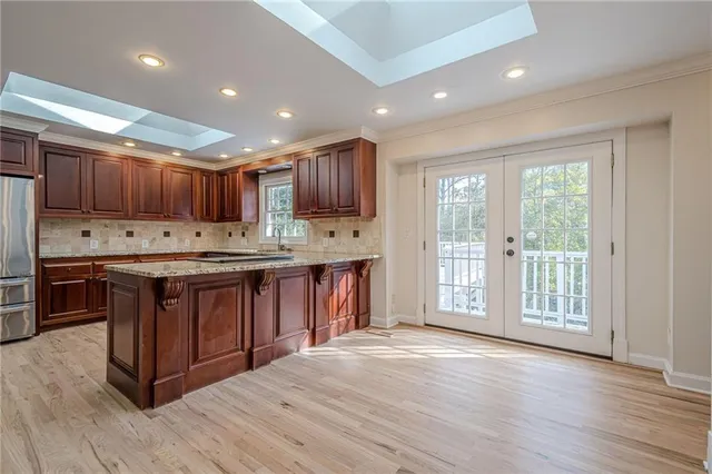 a kitchen with wooden floor and a stove
