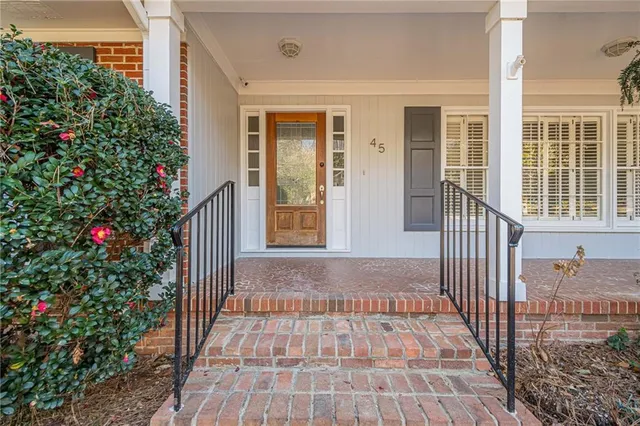 a view of a hallway with wooden floor and closet