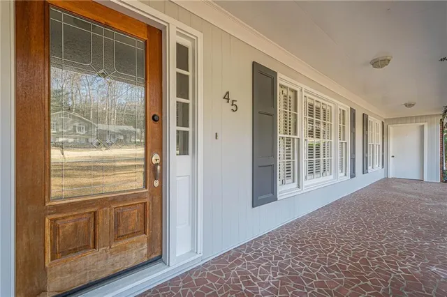 a view of an empty room and wooden floor