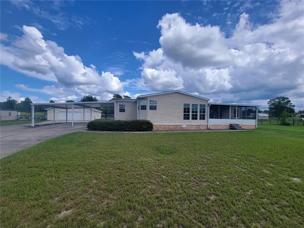 a view of a house with a back yard