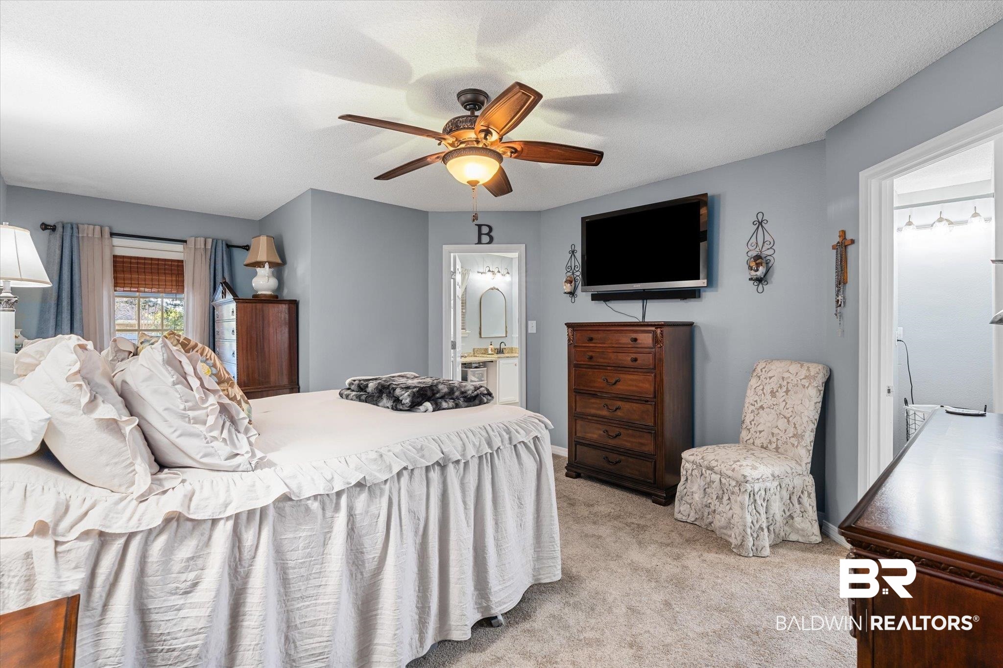 356 Collinwood Loop Foley, AL 36535 - Photo 13 of 21 Bedroom with ensuite bath, ceiling fan, light colored carpet, and a textured ceiling