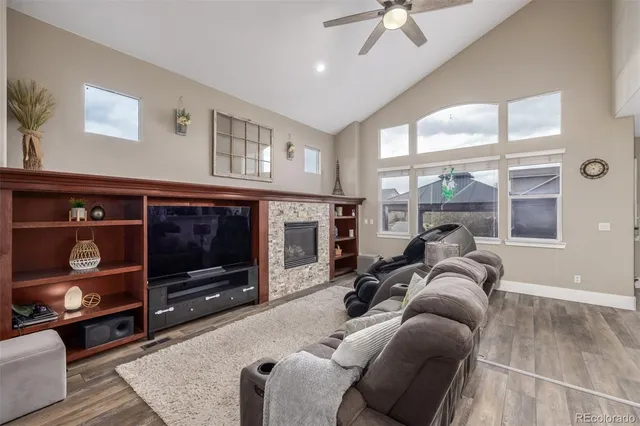 a living room with furniture a flat screen tv and a fireplace