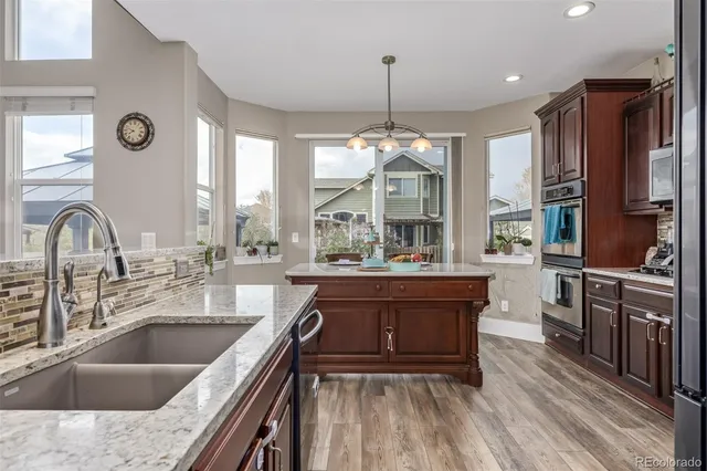 a large kitchen with stainless steel appliances a large center island and a stove