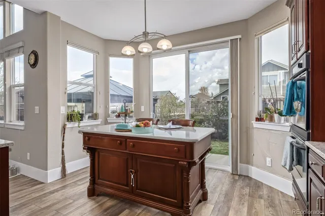 a room with a table chairs and wooden floor
