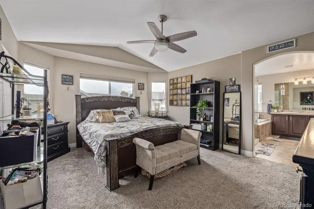 a bedroom with a large bed and a chandelier