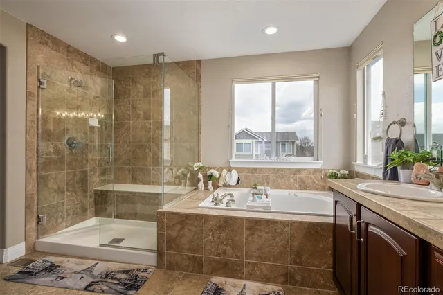 a view of walk in closet with clothes