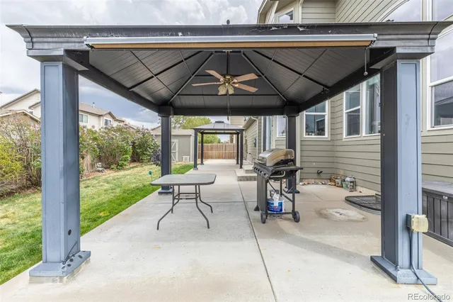 a patio with a table and chairs