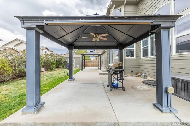 a view of a house with backyard porch and sitting area