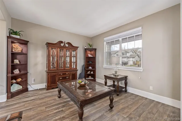 a living room with furniture a piano and a window