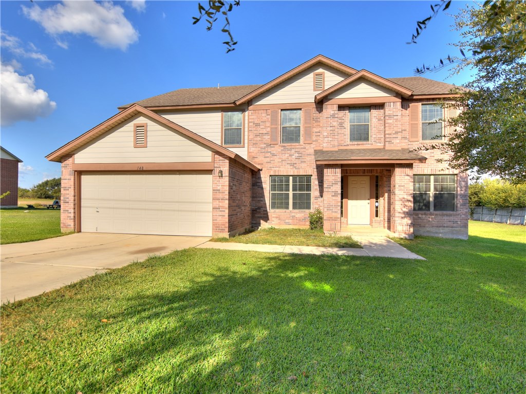 148 Campo De Oro Road Kyle, TX 78640 - Photo 1 of 1 a front view of a house with a yard and garage