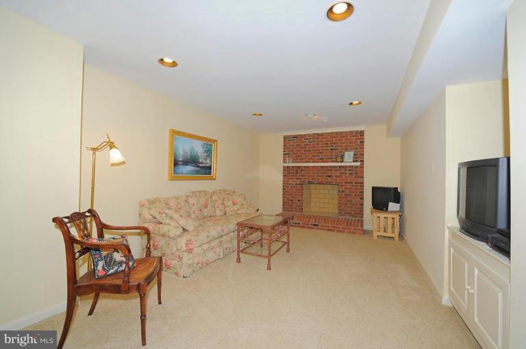 6583 Forsythia Street Springfield, VA 22150 - Photo 11 of 28 a living room with furniture and a flat screen tv