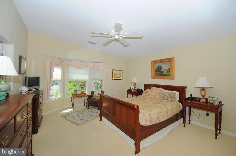 6583 Forsythia Street Springfield, VA 22150 - Photo 12 of 28 a bed room with a bed window and a chair