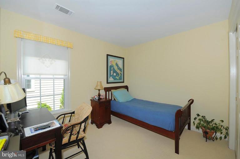 6583 Forsythia Street Springfield, VA 22150 - Photo 16 of 28 a bedroom with furniture and a window
