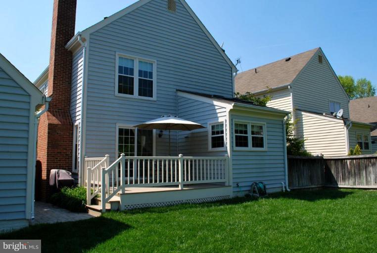 6583 Forsythia Street Springfield, VA 22150 - Photo 18 of 28 a view of a house with a yard and deck