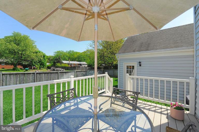 6583 Forsythia Street Springfield, VA 22150 - Photo 19 of 28 a view of a chair and table on the deck