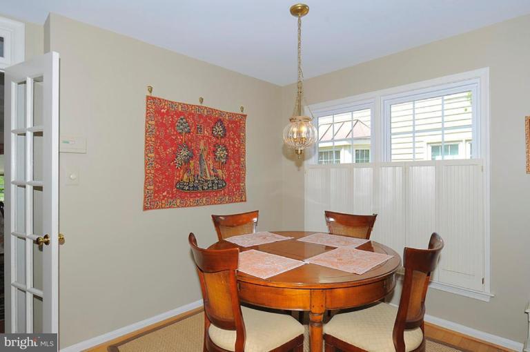 6583 Forsythia Street Springfield, VA 22150 - Photo 27 of 28 a view of a dining room with furniture window and wooden floor