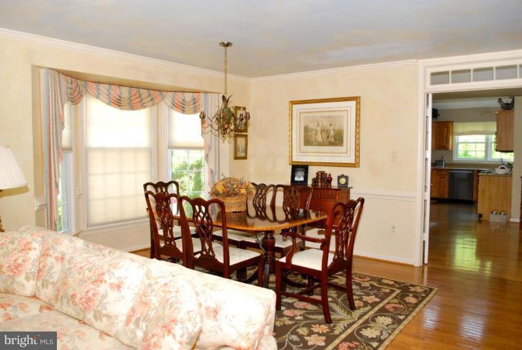 6583 Forsythia Street Springfield, VA 22150 - Photo 4 of 28 a view of a dining room with furniture window and wooden floor